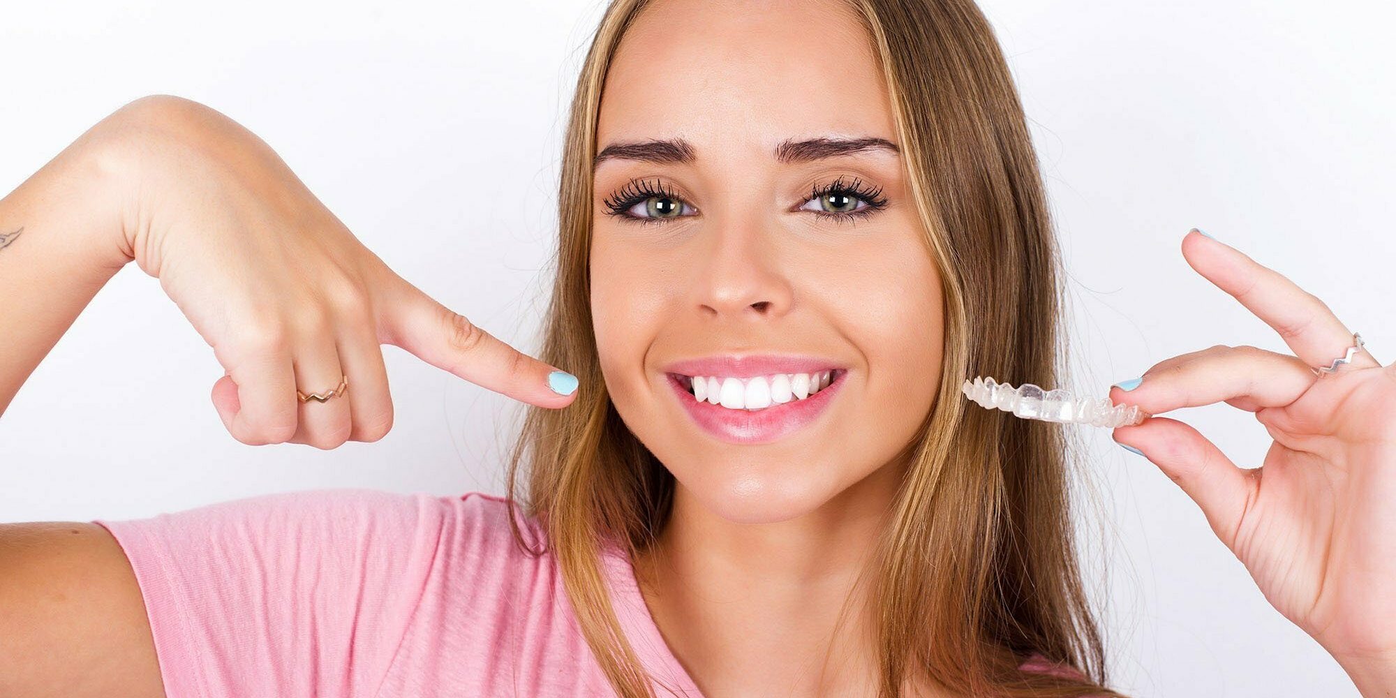 beautiful blonde girl wearing pink t-shirt on white background h