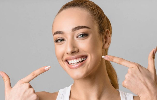 Orthodontic concept. Happy girl showing her beaming white teeth